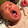 Kori is registered to the contest to win money with this photo: baby, yawning, close_up, face, mouth_open, sleepy, infant, skin, hand, clothing, ribbed, cute, newborn, expression, tongue, mouth, person, head, indoor, portrait