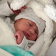 Gabriel participe au concours pour gagner de l'argent avec cette photo : baby, blanket, child, clothing, comfort, cozy, cute, face, hand, hat, indoors, infant, newborn, person, portrait, resting, sleeping, soft, swaddle, warm