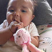 Rylann joined the competition — help win amazing prizes! adorable, baby, bunny, cheeks, child, closeup, clothing, cute, face, hand, indoor, infant, pattern, person, pillow, pink, portrait, soft_toy, stuffed_animal, toy