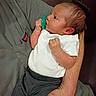 baby, newborn, infant, pacifier, white_shirt, gray_pants, arm, hand, person, holding, cradling, indoor, portrait, cute, small, skin, hair, face, clothing, resting