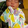 baby, camouflage, child, closeup, colorful_clothing, cute, face, floral_pattern, hand, indoors, infant, newborn, onesie, pacifier, peaceful, person, portrait, resting, sleeping, soft_fabric
