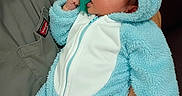 Rylann joined the competition — help win amazing prizes! baby, infant, blue_onesie, monster_costume, pacifier, hand, cute, fluffy, hood, horns, child, person, sitting, indoor, closeup, soft_texture, apparel, warm_clothing, portrait, adorable