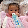 Rylann joined the competition — help win amazing prizes! baby, infant, child, bottle, feeding, blanket, pink_blanket, couch, portrait, close_up, face, eyes, hair, hand, sitting, cozy, indoors, star_pattern, soft_texture, family