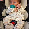 baby, car_seat, child, clothing, comfort, cute, face, floral_pattern, head, indoors, infant, newborn, pacifier, pajamas, person, portrait, resting, seat_belt, skin, young