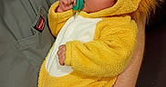 Rylann joined the competition — help win amazing prizes! baby, child, costume, cuddly, cute, face, fur, hand, holding, indoor, infant, lion, onesie, pacifier, person, plush, sleepwear, soft, toddler, yellow