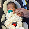 baby, car_seat, child, clothing, cute, expression, fingers, floral_pattern, hand, head, indoor, infant, newborn, onesie, pacifier, person, resting, safety, seatbelt, skin