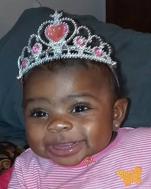 Aaliyah is registered to the contest to win money with this photo: baby, black_hair, cheek, child, crown, face, fashion_accessory, forehead, hair_accessory, head, headband, headgear, headpiece, jewellery, joy, lip, person, pink, smile, tiara