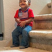 Theodore joined the competition — help win amazing prizes! toddler, child, smiling, sitting, stairs, carpet, red_shirt, jeans, indoor, happy, person, face, feet, sock, wall, home, casual, cute, portrait, young