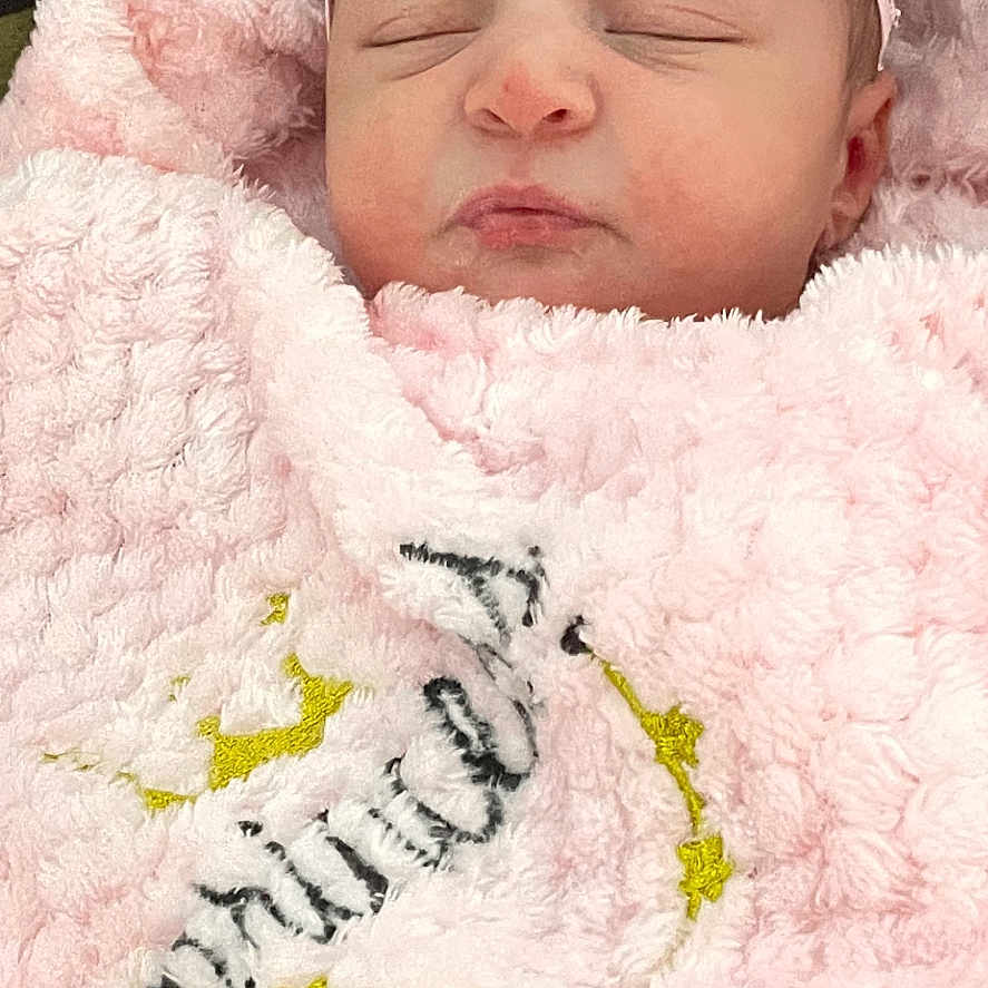 Emma joined the competition — help win amazing prizes! baby, blanket, bonnet, cap, clothing, crib, cushion, embroidery, face, hat, head, homedecor, newborn, pattern, person, photography, portrait, quilt, sleeping, towel