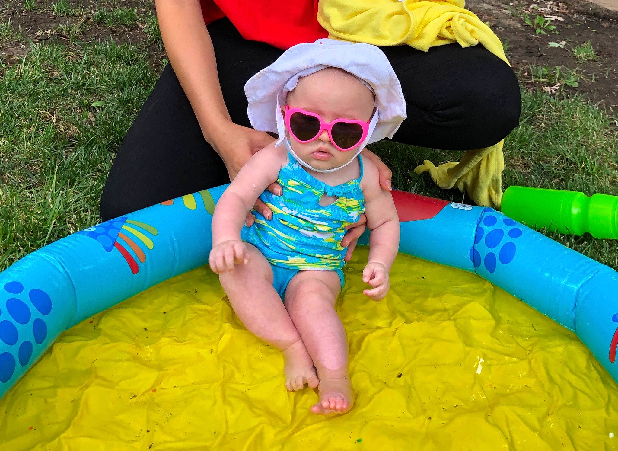 Astrid is registered to the contest to win money with this photo: child, fun, games, grass, inflatable, leisure, person, play, recreation, summer, sunglasses, toddler, yellow