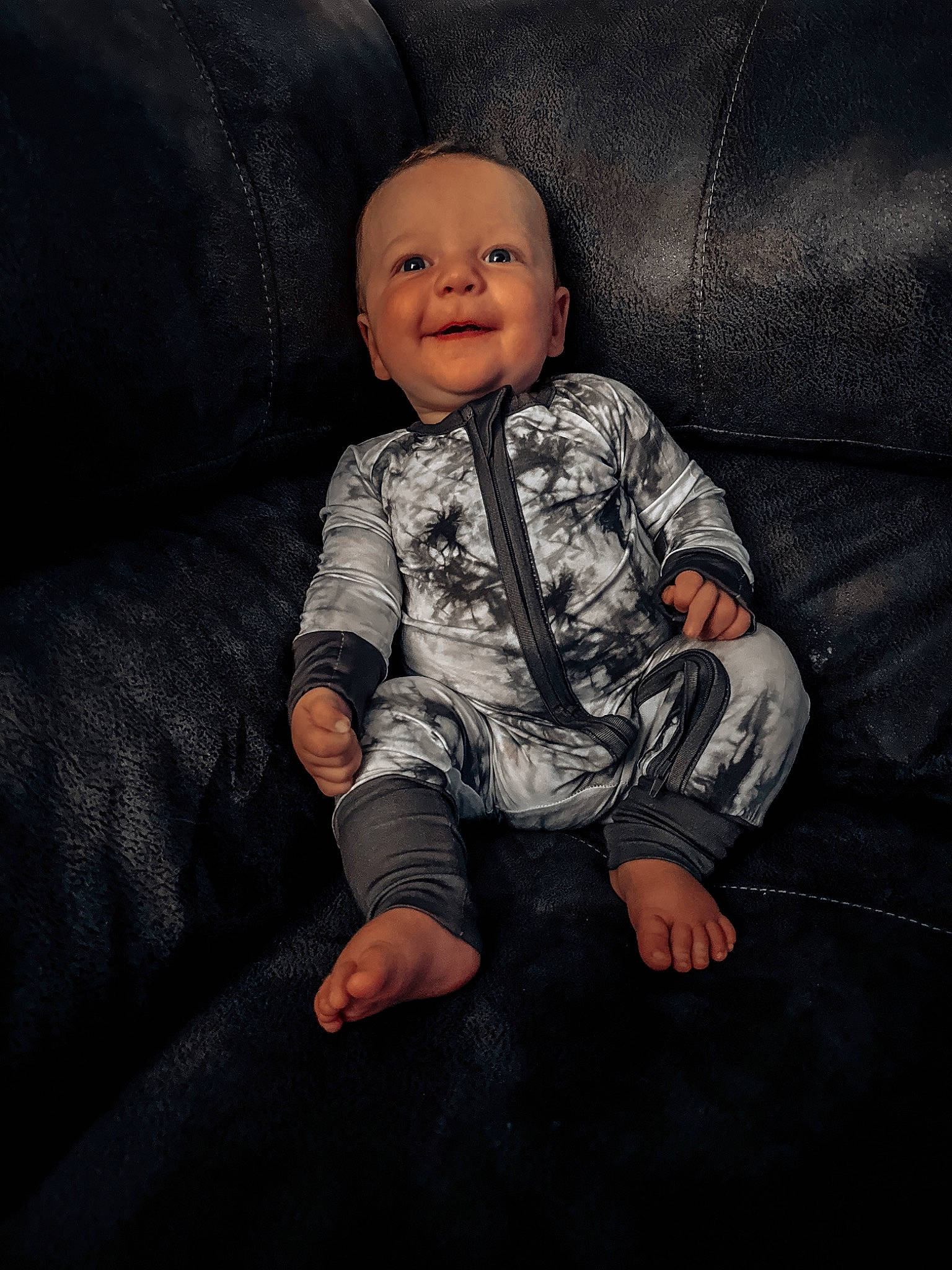 Kyson is registered to the contest to win money with this photo: baby, baby_toddler_clothing, cheek, child, comfort, couch, darkness, flash_photography, flooring, fun, grey, happy, pattern, person, sitting, skin, sleeve, smile, t_shirt, textile