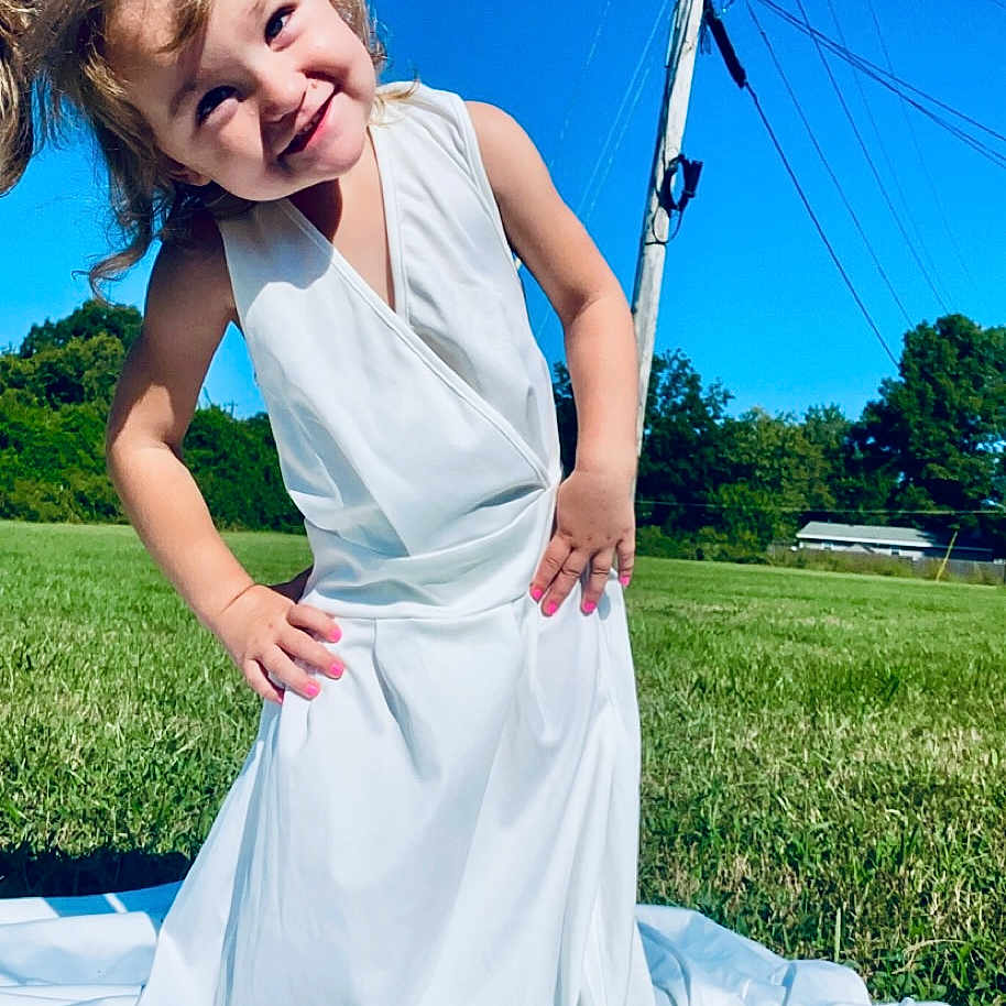Gracelynn is registered to the contest to win money with this photo: child, clothing, dress, eveningdress, face, fashion, female, formalwear, girl, gown, grass, head, lawn, person, photography, plant, portrait, summer, wedding, weddinggown