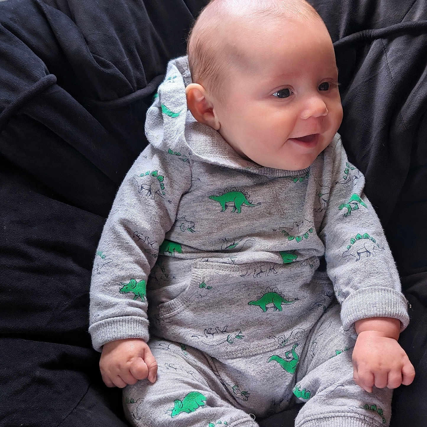 Aiden is registered to the contest to win money with this photo: baby, bodypart, chair, clothing, couch, face, finger, furniture, hand, head, hoodie, knitwear, longsleeve, pants, person, photography, portrait, sleeve, sweater, sweatshirt