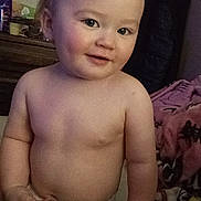 Abel is registered to the contest to win money with this photo: toddler, child, baby, smile, blanket, indoor, face, skin, person, cute, rosy_cheeks, shirtless, bedroom, furniture, cozy, young_child, head, expression, warm, playful