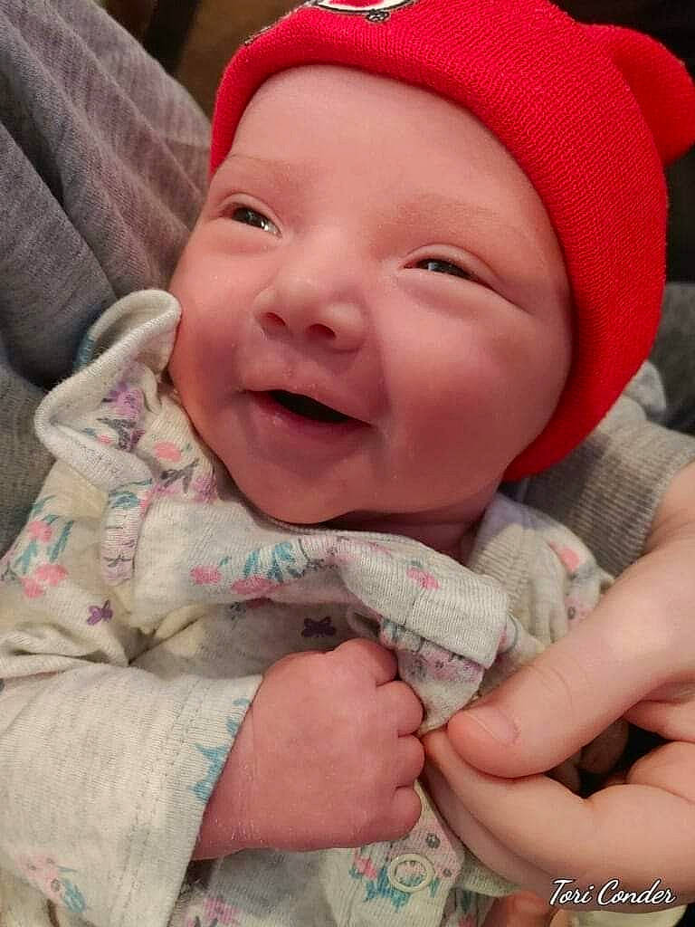 Justice is registered to the contest to win money with this photo: baby, baby_toddler_clothing, cap, cheek, chin, comfort, eye, face, finger, gesture, happy, head, headwear, lip, mouth, nose, person, pink, product, skin