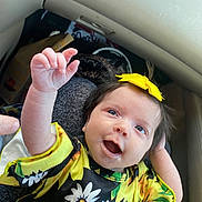 Makenna joined the competition — help win amazing prizes! baby, child, smiling, happy, yellow_bow, floral_dress, hand, face, person, infant, cute, indoors, clothing, sitting, skin, head, hair, bright_colors, joy, expression