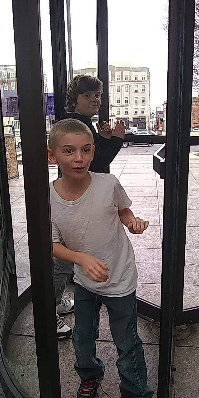 Noah is registered to the contest to win money with this photo: child, door, gesture, joy, person, shoulder, snapshot, standing, t_shirt