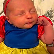 Penelope joined the competition — help win amazing prizes! baby, child, sleeping, snow_white_costume, red_bow, headband, blue_dress, yellow_skirt, red_sleeves, portrait, indoors, bed, blanket, close_up, face, infant, costume, cute, resting, photography