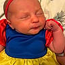baby, child, sleeping, snow_white_costume, red_bow, headband, blue_dress, yellow_skirt, red_sleeves, portrait, indoors, bed, blanket, close_up, face, infant, costume, cute, resting, photography