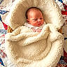 Penelope joined the competition — help win amazing prizes! newborn, baby, infant, child, portrait, sleepy, blanket, swaddled, cream_blanket, quilt, star_pattern, red, white, blue, basket, cozy, indoors, lying_down, face, photography