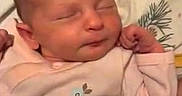 Penelope is registered to the contest to win money with this photo: newborn, baby, sleeping, portrait, face, closed_eyes, tiny_hands, fist, onesie, clothing, blanket, bedding, indoor, cozy, peaceful, infant, head, resting, disney_character, mickey_mouse