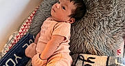 Ricah Olivia joined the competition — help win amazing prizes! baby, infant, pillow, blanket, soft_toys, clothing, lying_down, indoors, cute, child, pink, nursery, cozy, resting, portrait, newborn, warm, furniture, sleepwear, mittens