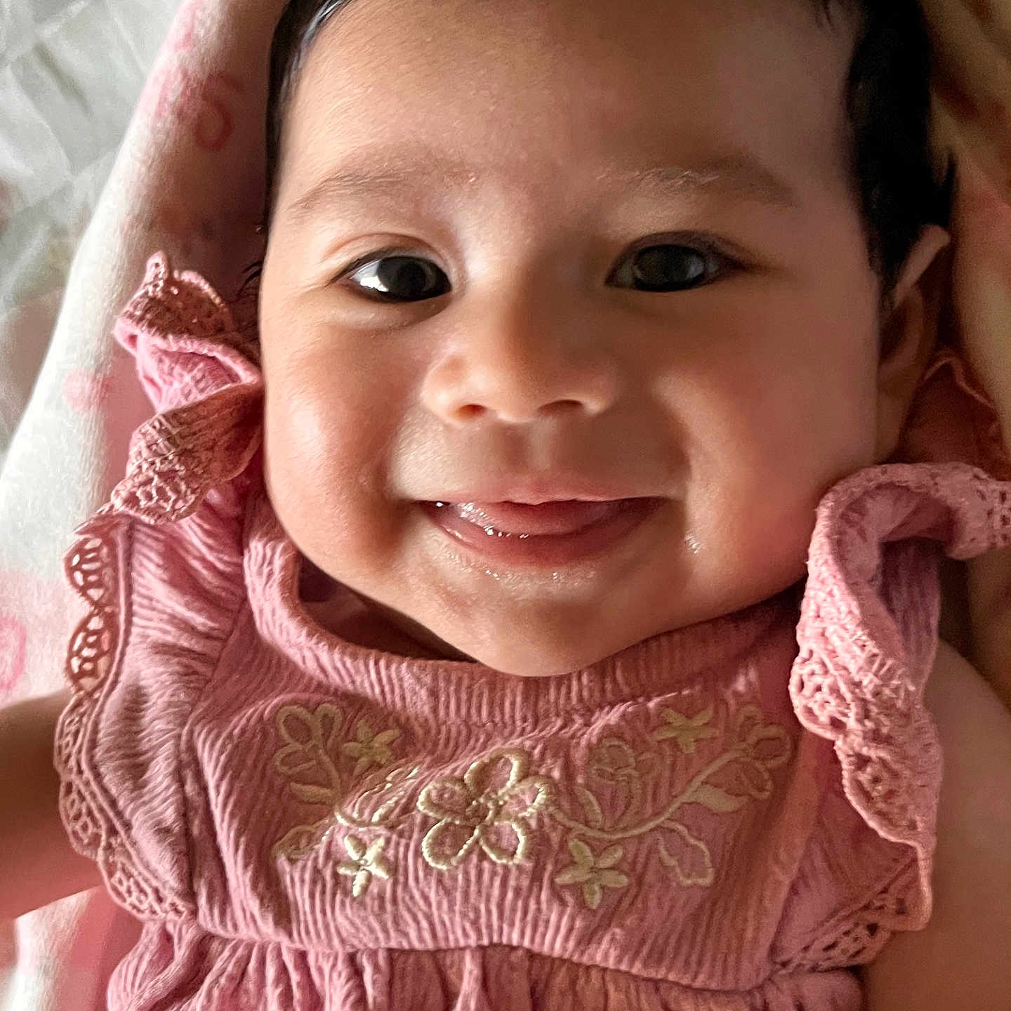 Ricah Olivia joined the competition — help win amazing prizes! baby, child, smiling, face, pink_dress, embroidery, blanket, close_up, cute, happy, infant, portrait, person, skin, young_child, indoors, head, tongue, expression, clothing