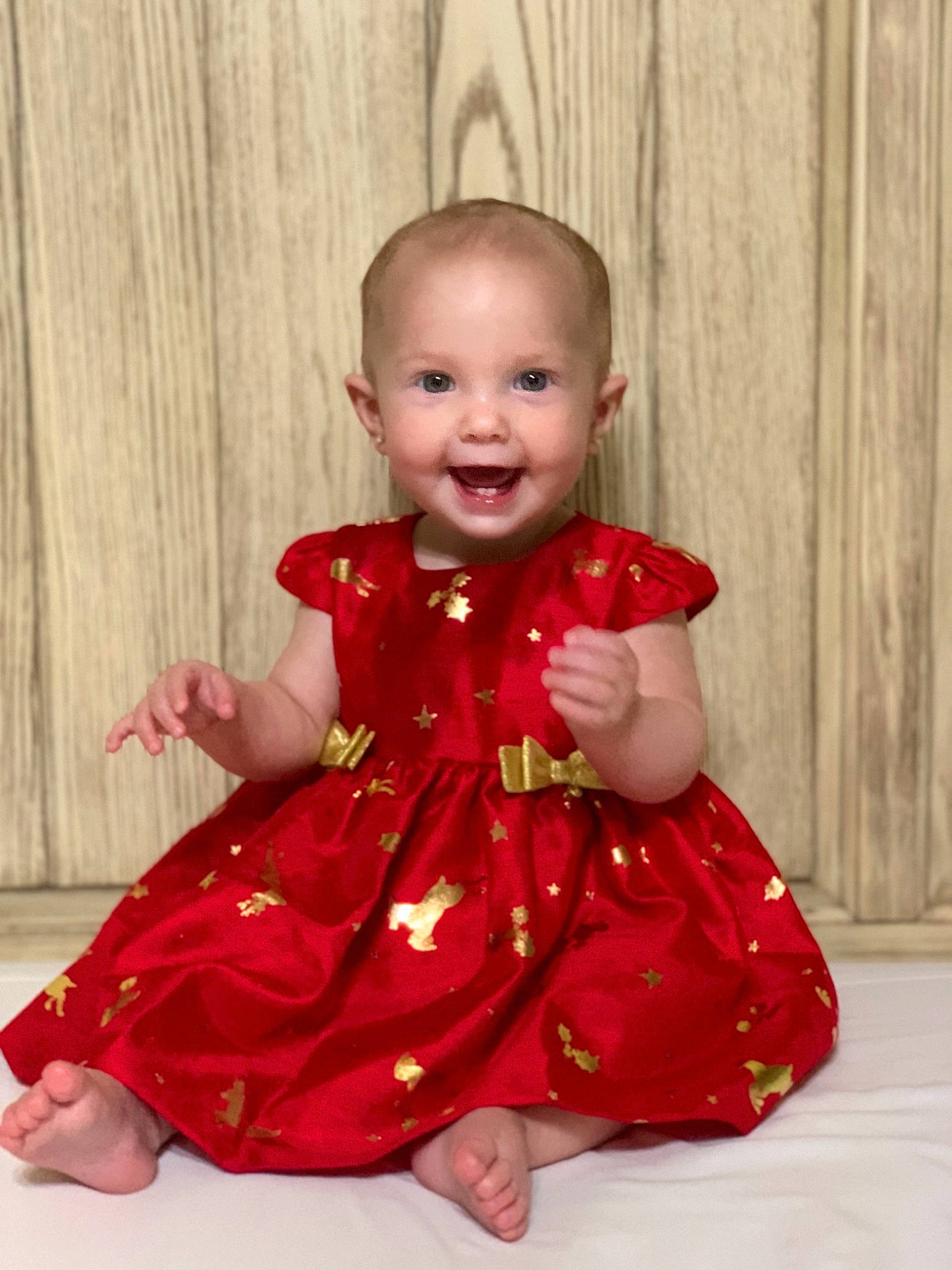 Ashton is registered to the contest to win money with this photo: baby, baby_toddler_clothing, cheek, child, chin, day_dress, dress, facial_expression, finger, floor, flooring, forehead, iris, joy, organ, pattern, person, pink, sitting, skin