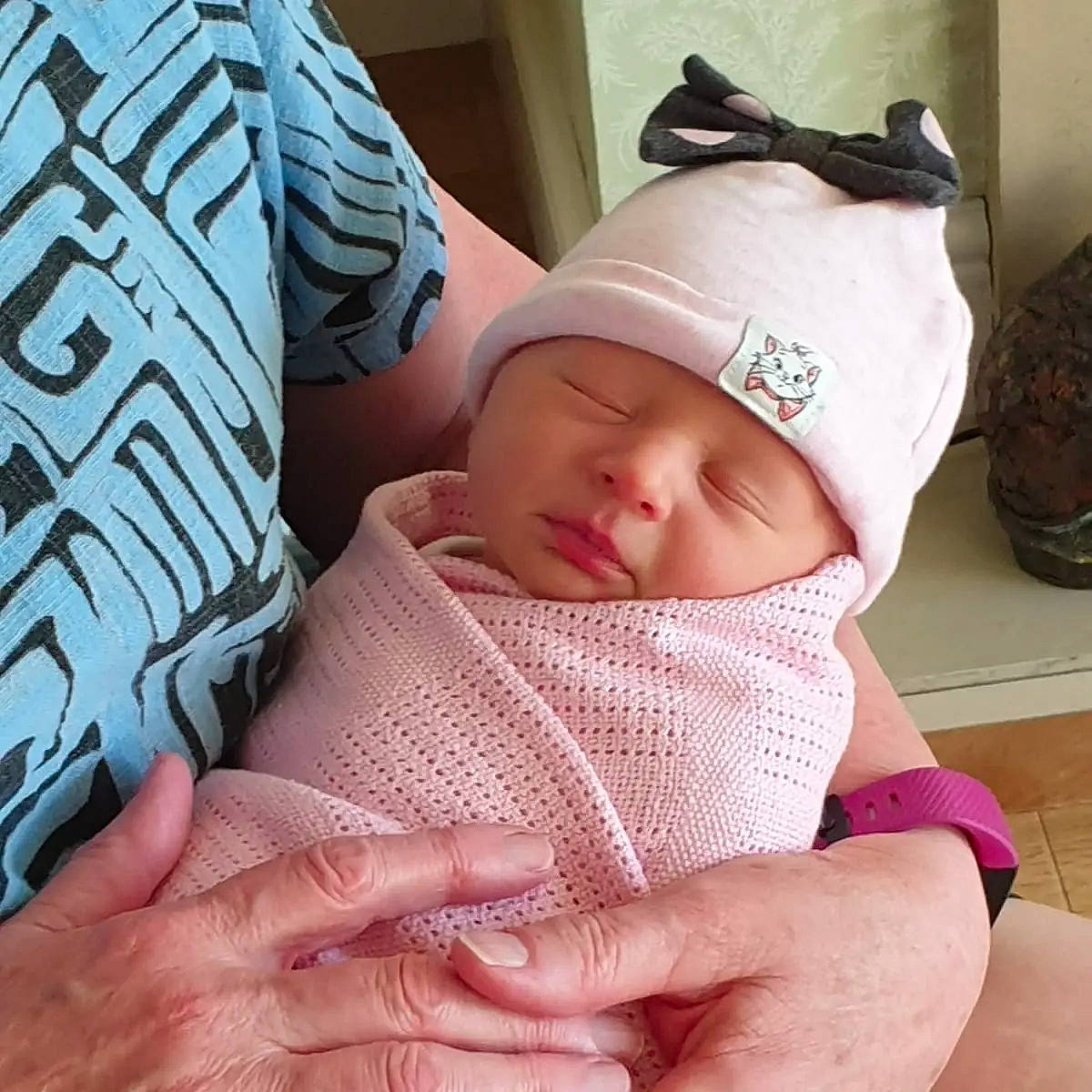 Cynthia joined the competition — help win amazing prizes! baby, baby_sleeping, baby_toddler_clothing, cap, cheek, comfort, eye, face, facial_expression, finger, gesture, hand, head, headwear, human_body, mouth, neck, person, skin, sleeve