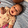 Hazel joined the competition — help win amazing prizes! baby, infant, child, portrait, lying_down, awake, wide_eyed, open_mouth, smiling, cherry_pattern, onesie, pacifier, bed, bedspread, blue_and_white, indoor, close_up, face, arm, family_photo
