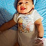 baby, infant, child, smiling, tongue_out, lying_down, portrait, indoor, blanket, blue_blanket, onesie, clothing, storybook_characters, winnie_the_pooh, tigger, adult_hands, cozy, happy, face, bed