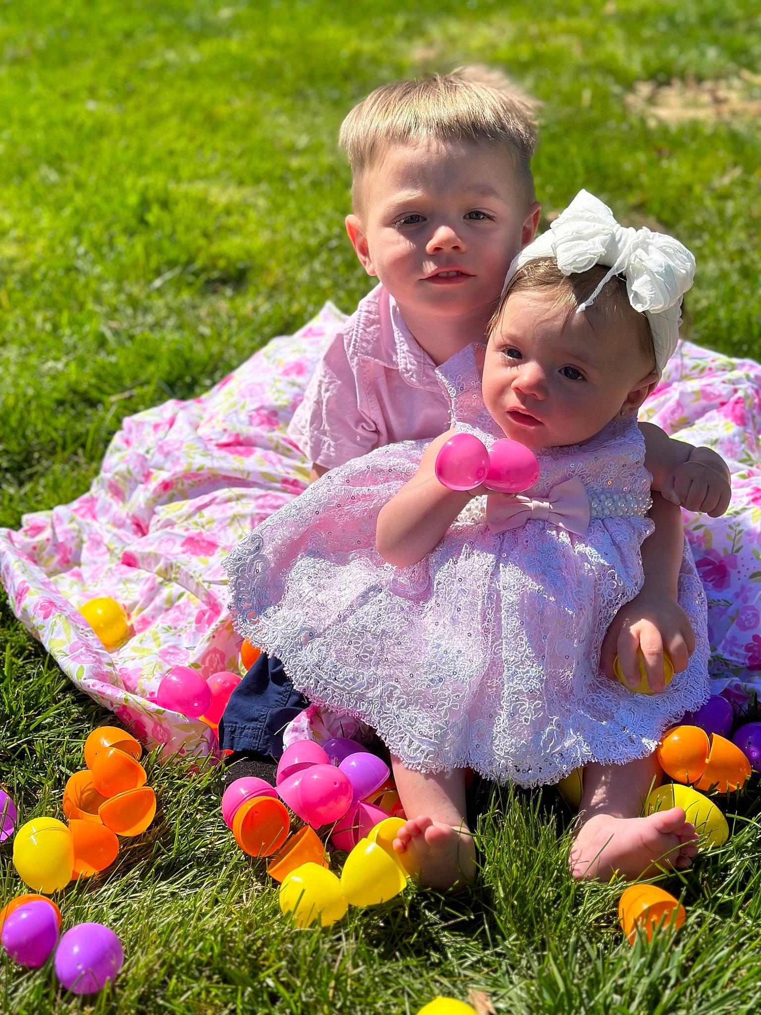 Anthony is registered to the contest to win money with this photo: baby, baby_toddler_clothing, botany, dress, face, fun, grass, happy, leaf, meadow, natural_environment, nature, people, people_in_nature, person, petal, photograph, pink, recreation, summer