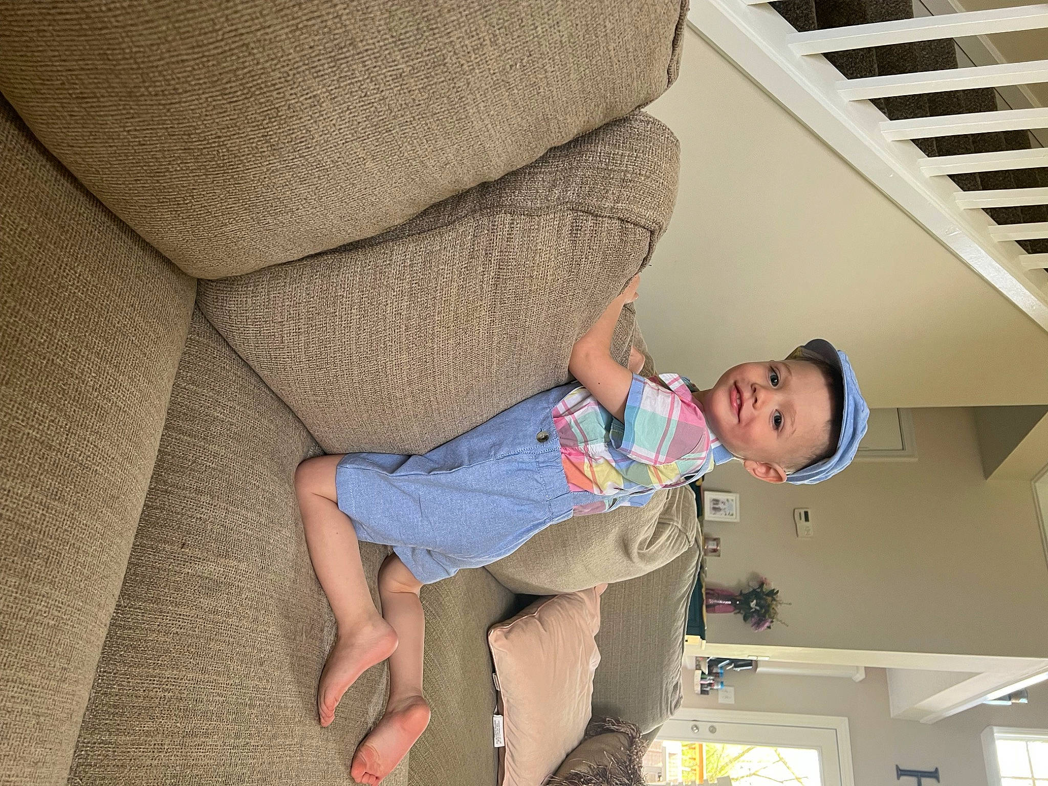 Anthony is registered to the contest to win money with this photo: car_seat, child, comfort, elbow, flooring, foot, fun, hat, human_leg, joy, knee, lap, leg, linens, person, room, sitting, t_shirt, thigh, vacation