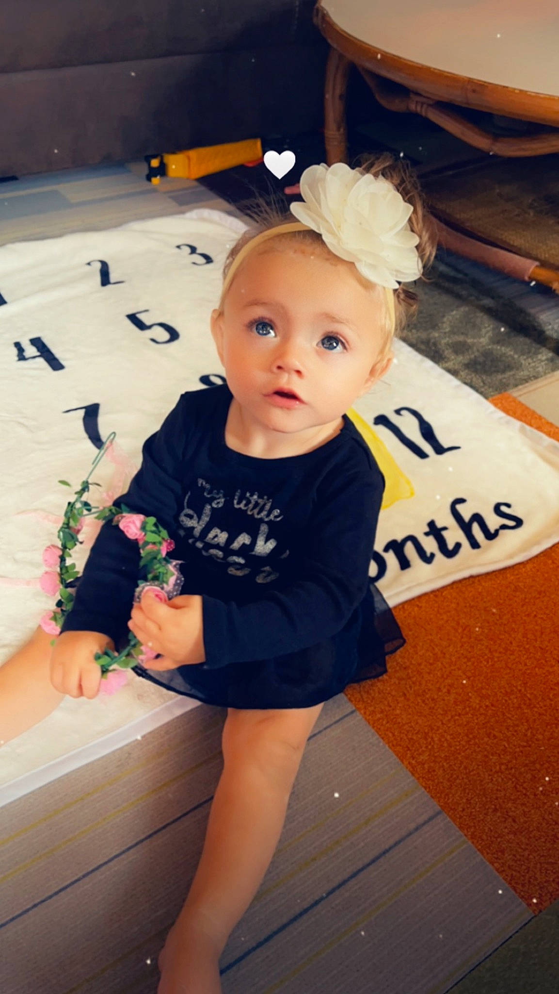 Brinley joined the competition — help win amazing prizes! baby, baby_toddler_clothing, child, facial_expression, fashion_accessory, fashion_design, flooring, fun, happy, human_leg, knee, pattern, person, room, shorts, sitting, skin, sleeve, surprise, t_shirt