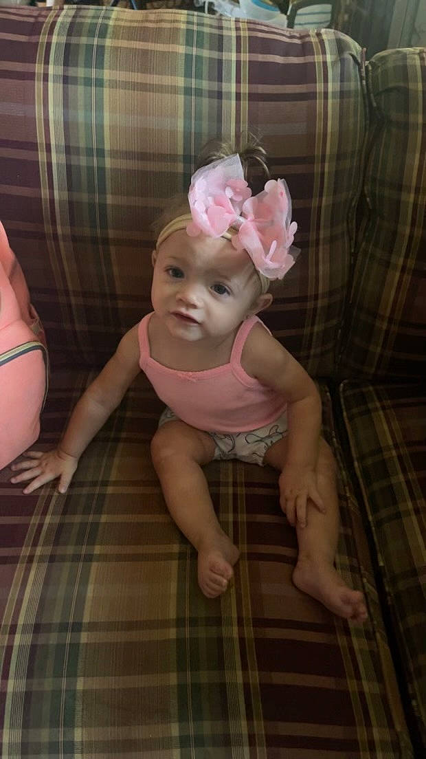 Brinley joined the competition — help win amazing prizes! arm, baby, baby_toddler_clothing, cheek, comfort, eye, flooring, hand, headwear, iris, leg, pattern, person, pink, plaid, skin, smile, tartan, textile, thigh