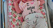 Amara joined the competition — help win amazing prizes! newborn, baby, infant, hospital, bassinet, floral_blanket, pink, clothing, hat, cute, lying_down, birth_announcement, baby_girl, face, person, pajamas, bed, hospital_room, newborn_clothes, portrait