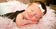 Eden is registered to the contest to win money with this photo: baby, newborn, sleeping, blanket, bow, headband, pink, fluffy, cushion, resting, infant, cute, peaceful, portrait, soft, cozy, child, young, adorable, relaxing