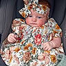 baby, infant, car_seat, floral_dress, headband, socks, blanket, child, portrait, cute, seated, indoors, clothing, small_hands, blue_eyes, expression, fabric, soft, comfort, accessory