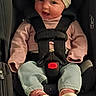 baby, car_seat, headband, pink_clothing, blue_pants, baby_shoes, infant, child, straps, sitting, cute, indoor, smiling, face, person, seat, safety_harness, young_child, adorable, expression