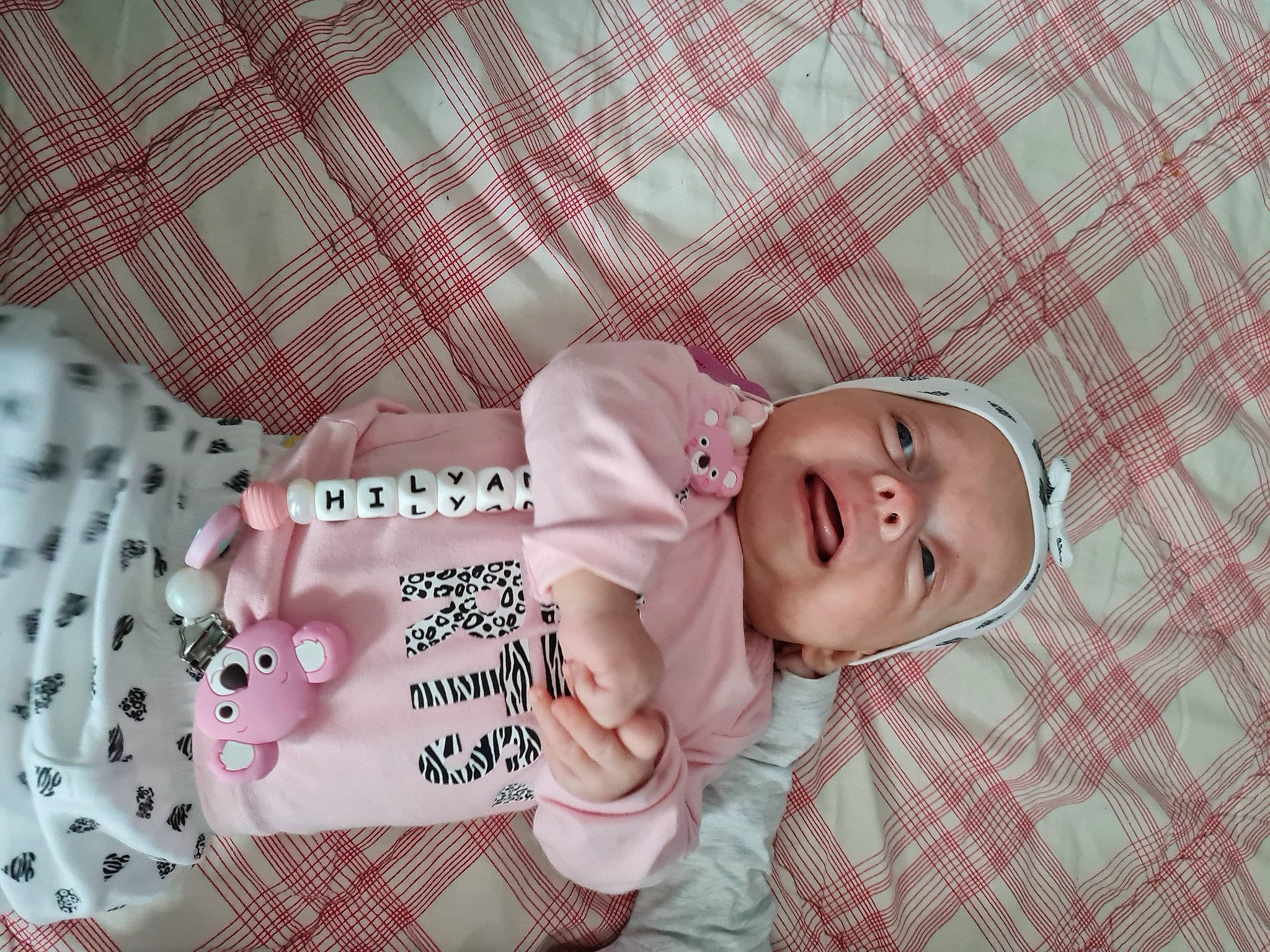 Hilyana participe au concours pour gagner de l'argent avec cette photo : baby, baby_products, baby_toddler_clothing, cheek, child, comfort, eyelash, happy, headwear, linens, lip, pattern, person, pink, product, skin, sleeve, smile, sweetness, textile