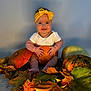 baby, pumpkin, autumn_leaves, fall, orange, yellow, headband, smiling, sitting, cute, child, seasonal, harvest, decor, holiday, portrait, indoor, cozy, festive, cute_baby