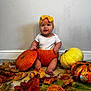 baby, child, pumpkin, yellow_bow, autumn_leaves, fall, carpet, white_wall, cute, smiling, orange_pumpkin, white_pumpkin, decor, indoors, seasonal, holiday, festive, happy, sitting, headband