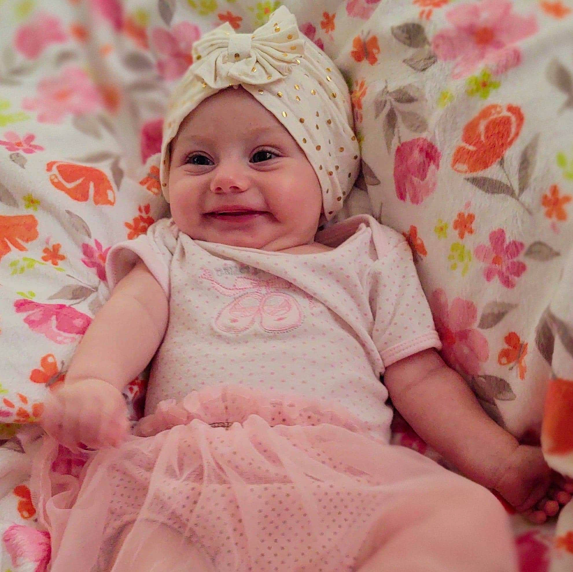 Evalynn joined the competition — help win amazing prizes! baby, baby_laughing, baby_toddler_clothing, beauty, cap, child, comfort, dress, event, fashion_accessory, happy, headgear, headwear, magenta, pattern, person, pink, skin, sleeve, smile