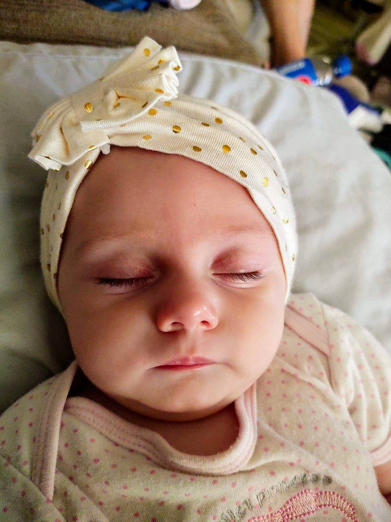 Evalynn is registered to the contest to win money with this photo: baby, baby_toddler_clothing, cap, cheek, ear, eye, eyebrow, eyelash, forehead, happy, headgear, headwear, lip, mouth, neck, nose, person, pink, skin, sleeve
