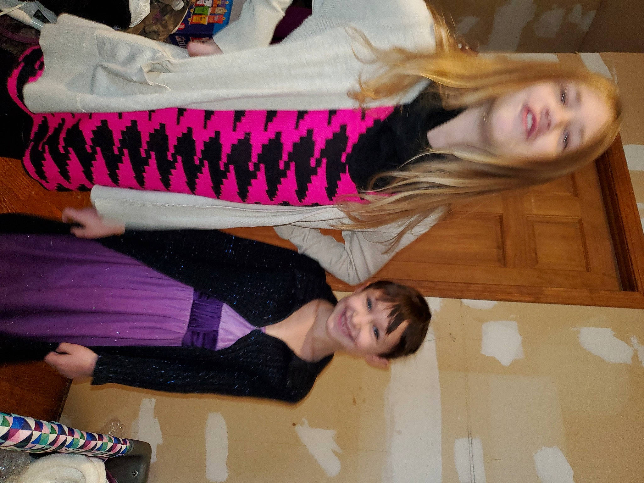 Nevaeh is registered to the contest to win money with this photo: child, comfort, flooring, fun, happy, hardwood, head, human_leg, joint, joy, knee, leg, leisure, person, pink, room, smile, sock, sportswear, thigh