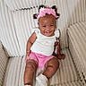 baby, chair, child, closeup, curly_hair, fashion, flower_crown, happy, indoor, infant, photography, pink_clothing, portrait, shorts, sitting, smiling, sneakers, socks, upholstery, white_shirt