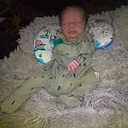 Paxston joined the competition — help win amazing prizes! newborn, baby, sleeping, onesie, blanket, pillow, resting, infant, cozy, patterned_clothing, soft_texture, indoor, peaceful, child, cute, portrait, fabric, comfort, nap, peace