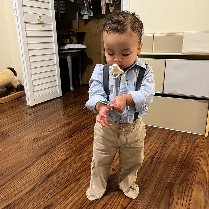 Liam is registered to the contest to win money with this photo: bodypart, boy, cabinet, child, clothing, electronics, face, finger, furniture, hand, hardwood, head, indoors, interiordesign, male, pants, person, photography, plywood, wood