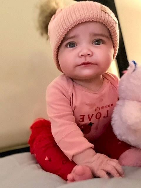 Anahi is registered to the contest to win money with this photo: baby, baby_toddler_clothing, cap, cheek, child, clothing, comfort, face, happy, head, headgear, headwear, lip, magenta, nose, outerwear, person, pink, skin, sleeve