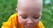 Prometheus joined the competition — help win amazing prizes! baby, child, yellow_shirt, outdoor, greenery, grass, hand, face, curious, cute, infant, portrait, nature, playing, young, head, skin, eyelashes, expression, person